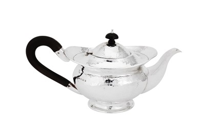 Lot 550 - A George V 'Arts and Crafts' sterling silver teapot, Birmingham 1926 by Henry Williamson Ltd