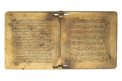 Lot 403 - AN ENGRAVED BRASS QUR'ANIC BOOK WITH MATCHING CASE
