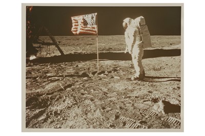 Lot 433 - Buzz Aldrin posing for a photograph beside the US flag
