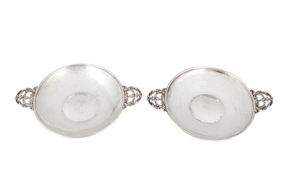 Lot 543 - A pair of George V 'Arts and Crafts' sterling silver twin handled dishes, Birmingham 1922 by A. E. Jones