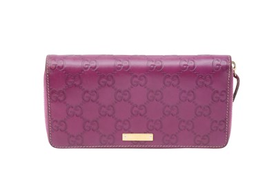 Lot 235 - Gucci Magenta GG Zip Around Long Wallet