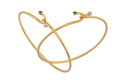 Lot 138 - A pair of diamond, ruby and emerald bangles
