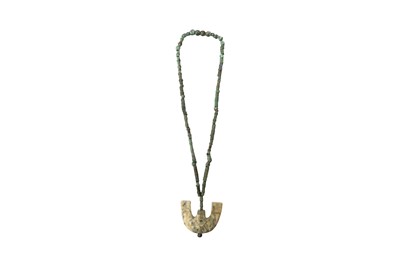 Lot 11 - A CHINESE LIANGZHU-STYLE JADE PENDANT