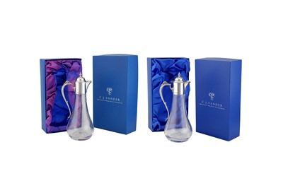 Lot 357 - A pair of Elizabeth II sterling silver mounted claret jugs, Sheffield 2000 by C. J. Vander
