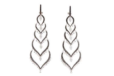 Lot 109 - Stephen Webster | A large pair of diamond and black diamond pendent earrings, 2014