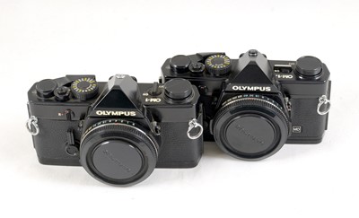 Lot 76 - A Pair of Black Olympus OM-1 Bodies.