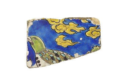 Lot 227 - A SAFAVID CUERDA SECA POTTERY TILE FRAGMENT