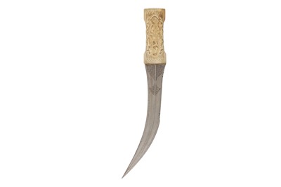 Lot 182 - λ A QAJAR WALRUS IVORY-HILTED KHANJAR STEEL DAGGER
