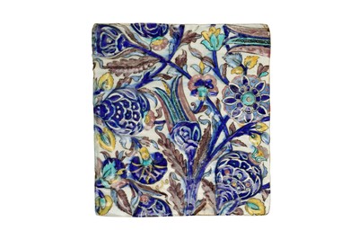 Lot 222 - A QAJAR IZNIK-STYLE MOULDED POTTERY TILE