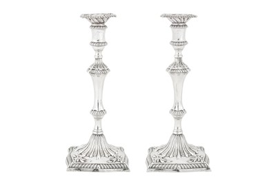 Lot 498 - A pair of George III sterling silver cast candlesticks, London 1776 by John Carter