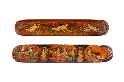 Lot 255 - TWO LACQUERED PAPIER-MÂCHÉ PEN CASES (QALAMDAN) WITH WINGED ANGELS AND QAJAR MAIDENS