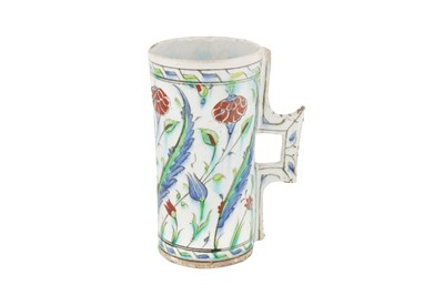 Lot 392 - AN IZNIK POTTERY TANKARD