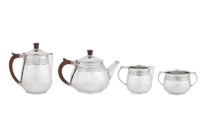 Lot 337 - A George V ‘Arts and Crafts’ sterling silver four-piece tea and coffee service, Birmingham 1935 by Arthur Matthews