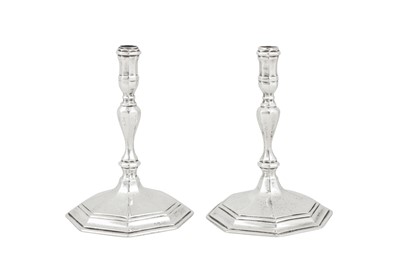 Lot 359 - A pair of George V sterling silver cast tapersticks, London 1933 by Richard Comyns