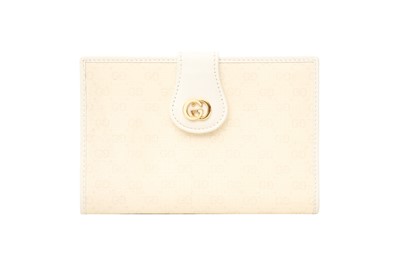 Lot 91 - A GUCCI IVORY BI-FOLD WALLET