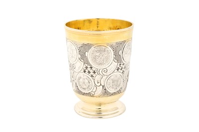 Lot 229 - A mid-18th century German parcel gilt silver coin set beaker, Berlin circa 1740 by Carl Ludwig Grube