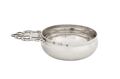 Lot 471 - A George I Britannia standard silver side handled porringer, London 1717 by Joseph Clare I (reg. 25th Sep 1713) probably overstriking another
