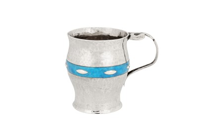 Lot 249 - An Edwardian ‘arts and crafts’ sterling silver and enamel christening mug, London 1902 by William Hutton and Sons
