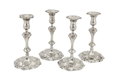 Lot 444 - Two pairs of George III sterling silver cast candlesticks, London 1762 by Jacob Marsh and London 1774 by John Arnell