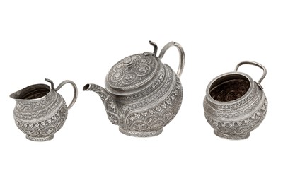 Lot 98 - A late 19th / early 20th century Anglo - Indian unmarked silver three-piece tea service, Kashmir circa 1900