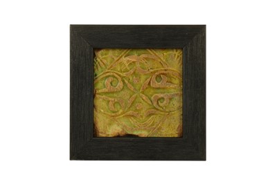 Lot 45 - A SMALL MOULDED OLIVE GREEN-GLAZED POTTERY TILE