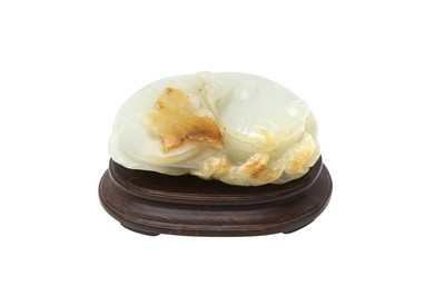 Lot 124 - A CHINESE WHITE AND RUSSET JADE 'CAT AND BUTTERFLY' CARVING