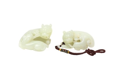 Lot 123 - TWO CHINESE PALE-CELADON JADE 'LION DOG' CARVINGS