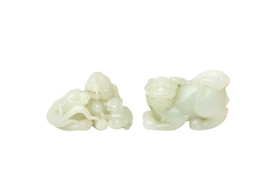 Lot 122 - TWO CHINESE PALE-CELADON JADE 'LION DOG' CARVINGS