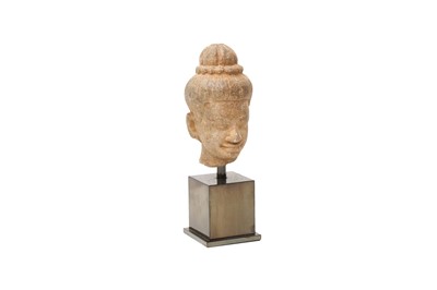 Lot 690 - A KHMER CARVED STONE HEAD OF VISHNU