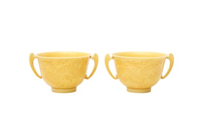 Lot 142 - A PAIR OF CHINESE YELLOW-GLAZED INCISED 'DRAGON' TWIN-HANDLED CUPS