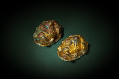 Lot 135 - A PAIR OF CHINESE GILT-BRONZE 'CAMEL' MAT WEIGHTS