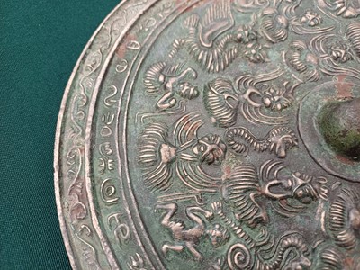 Lot 486 - A CHINESE BRONZE 'IMMORTALS' MIRROR