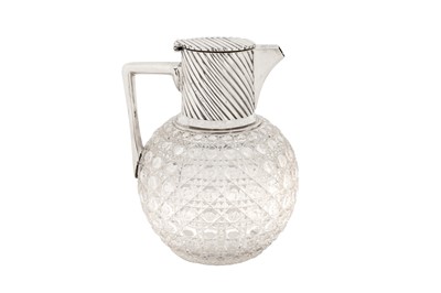 Lot 359 - A Victorian sterling silver mounted glass claret jug, London 1890 by Rupert Favell and Henry Elliott