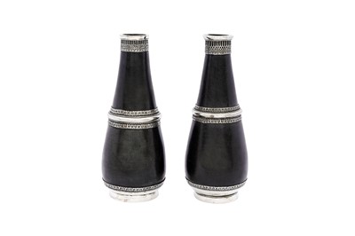 Lot 190 - A PAIR OF ZINC ALLOY HUQQA BASES WITH SILVER MOUNTS