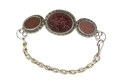 Lot 32 - A TALISMANIC BAZUBAND (ARMBAND) WITH INSCRIBED CARNELIAN BEADS