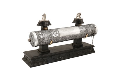 Lot 119 - An early 20th century Ceylonese (Sri Lankan) unmarked silver scroll holder upon stand, Kandy dated 1936