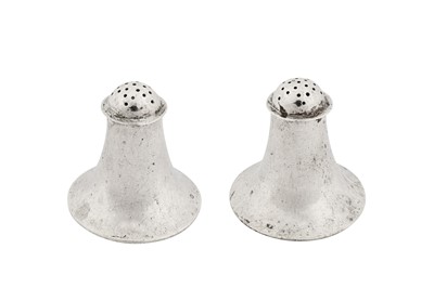 Lot 250 - A pair of George V ‘Arts and Crafts’ sterling silver peppers or condiments, London 1910 by Guild of Handicraft (George Hart)