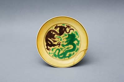 Lot 144 - A CHINESE YELLOW-GROUND 'DRAGONS' SAUCER DISH
