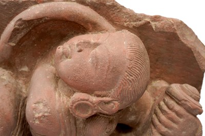 Lot 101 - A CARVED RED SANDSTONE FIGURE OF FEMALE WARRIORS