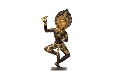 Lot 548 - A HIMALAYAN NEPALESE GILT-BRONZE FIGURE OF VAJRAYOGINI / DAKINI