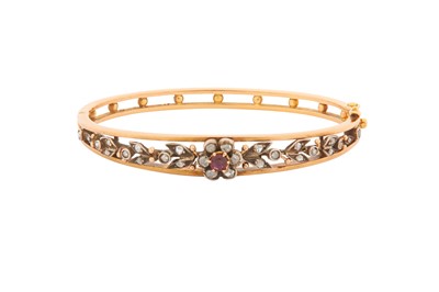 Lot 20 - A DIAMOND AND RUBY BANGLE