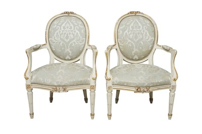 Lot 398 - A PAIR OF FRENCH LOUIS XVI STYLE WHITE PAINTED AND PARCEL GILT FAUTEUIL ARMCHAIRS