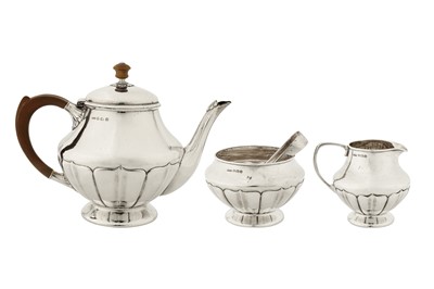 Lot 307 - A George V ‘Arts and Crafts’ sterling silver three-piece tea service, Birmingham 1927 by William Hair Haseler for Liberty