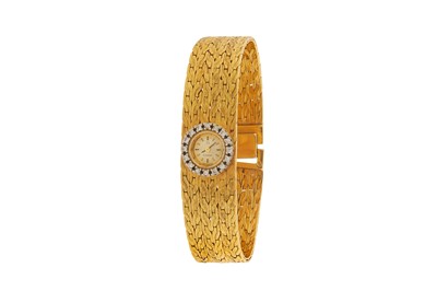 Lot 212 - OMEGA - AN 18K GOLD AND DIAMOND-SET BRACELET WATCH