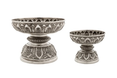 Lot 151 - A graduated pair of early 20th century Cambodian unmarked silver dish on stands (tok), circa 1930