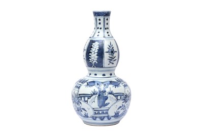 Lot 760 - A CHINESE MING-STYLE BLUE AND WHITE DOUBLE GOURD VASE