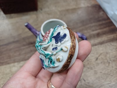 Lot 421 - A CHINESE FAMILLE-ROSE MOULDED 'BLOSSOMS' TEAPOT, COVER AND SAUCER