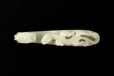 Lot 139 - A CHINESE PALE-CELADON JADE 'DRAGON' BELT HOOK