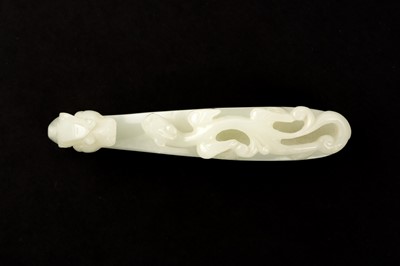 Lot 140 - A CHINESE PALE-CELADON JADE 'DRAGON' BELT HOOK
