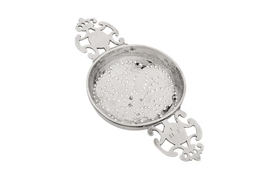 Lot 474 - A George I sterling silver lemon strainer, London 1722 by John Albright